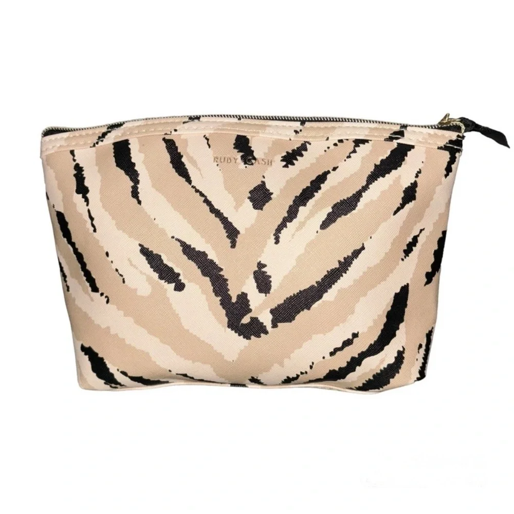 Ruby Cash animal print top zipper makeup bag. Black, tan and cream.